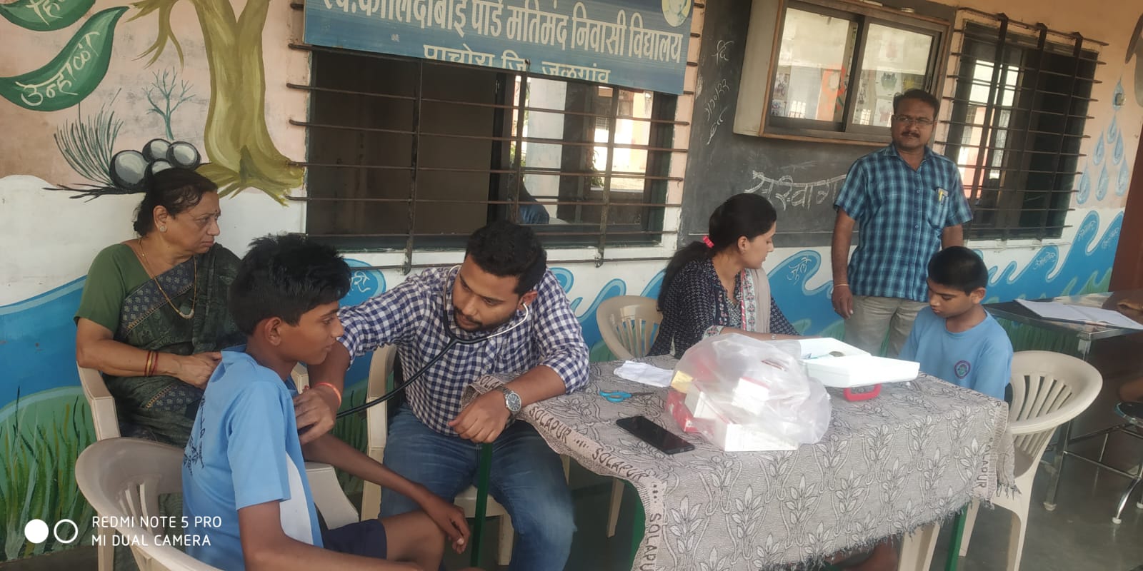 A student having a health check-up with a stethoscope